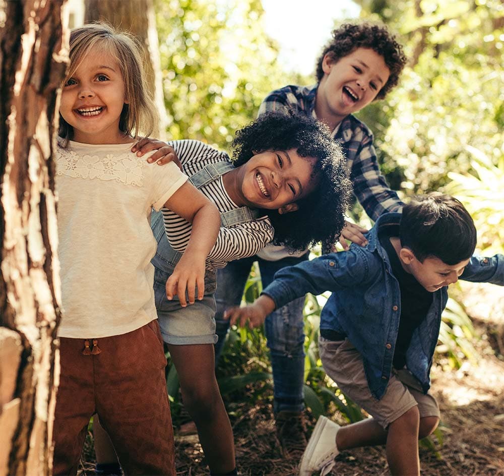 Four kids smiling playfully